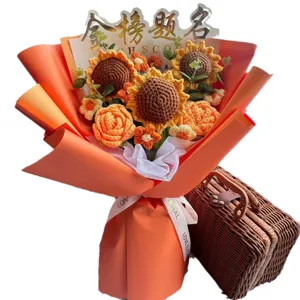 Handmade knitted sunflower and rose yarn bouquet in elegant orange gift wrapping