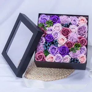 Detailed view of colorful soap rose flowers arrangement inside a black square gift box.