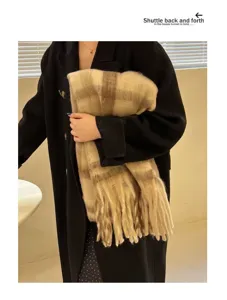 Detail showing thick mohair texture and beige plaid pattern of a warm winter scarf