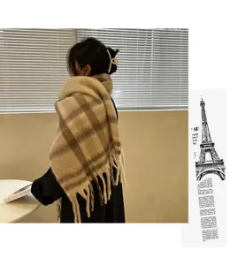 Close-up back view of model wearing a thick plaid mohair scarf with oversized tassels