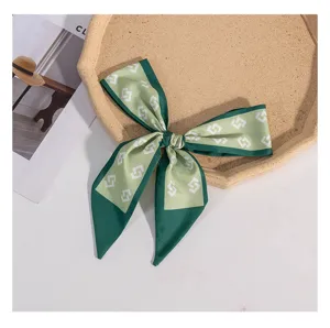Green geometric print silk ribbon scarf, narrow long design for bag handle or hair accessory.