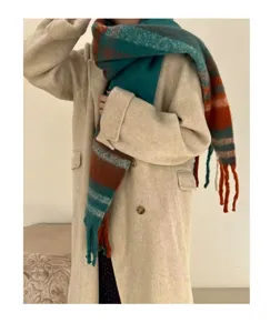 Detailed view of thick mohair scarf with colorful plaid pattern and long tassels