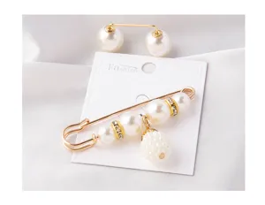 Detailed view of elegant pearl safety pin brooch with gold rhinestone accents