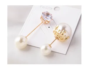 Close-up view of elegant pearl anti-exposure pins featuring clear cubic zirconia and gold plating