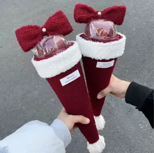 Creative Christmas DIY plush apple bouquet featuring a large red bow and festive labels