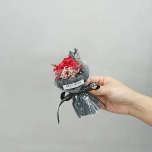 Close-up detail of a mini preserved flower bouquet in black wrap, perfect gift choice.