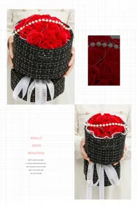 Close up detail of red soap rose flower bouquet in tweed gift box with pearl chain decor.