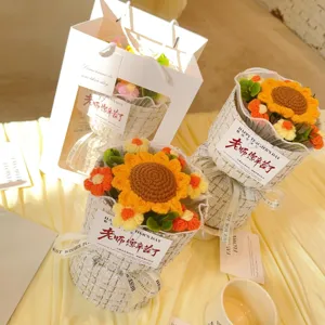 Close-up detail of handmade crochet sunflower bouquet with gift bag and elegant wrap.