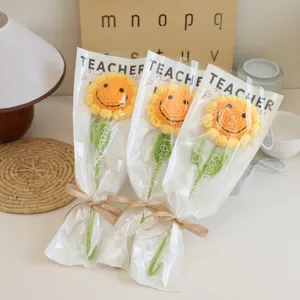 Handmade crochet sunflower bouquet in transparent wrapper, perfect creative gift for teachers.