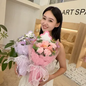 Close-up of model holding pink and purple soap flower bouquets for Mother's Day gift