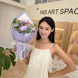 Asian woman holding a purple soap flower bouquet with carnations and lilies for gifts