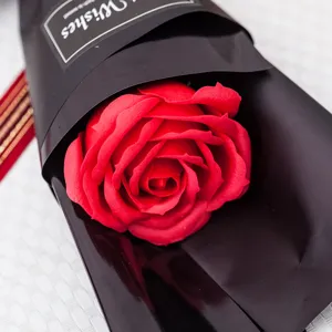 Single red soap rose flower in black gift wrapping paper for romantic gifts and special occasions