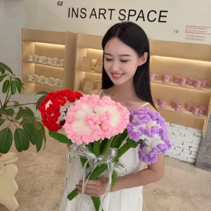 Detailed view of handmade crochet yarn carnations held by a professional model