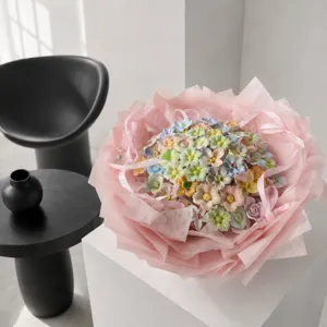 Ceramic flower bouquet detail view, dopamine color pastel ceramic flowers with pink gift wrapping.