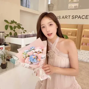 Asian model holding a romantic soap flower bouquet with pink and blue blossoms