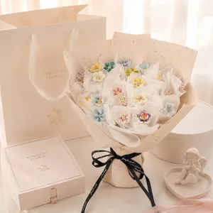 Exquisite handmade ceramic flower bouquet detail showing pastel petals and elegant gift packaging.