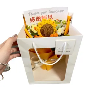 Handmade crochet sunflower bouquet in a white gift bag for Teacher's Day, perfect lasting gift.