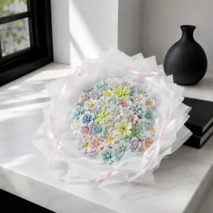 Detailed view of handcrafted colorful ceramic flower bouquet wrapped in elegant white paper.