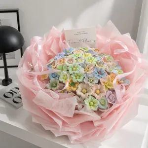 Handmade ceramic flower bouquet in vibrant dopamine colors with pink wrapping paper gift for her.