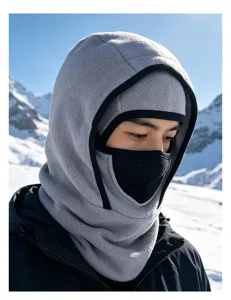 Detailed view of men's gray fleece winter balaclava hood worn in a snowy mountain scene.