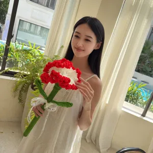 Asian model holding a handcrafted red and white crocheted carnation flower gift