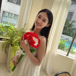 Handmade red and white crochet carnation flower bouquet held by model for gift display