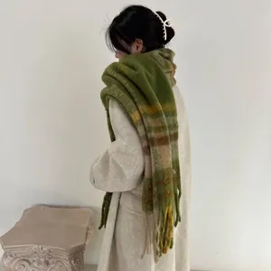 Stylish autumn winter thick plaid mohair scarf with fringes worn over a light beige coat