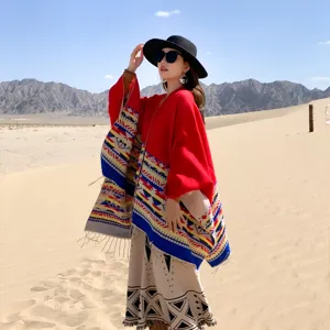 Ethnic geometric print poncho with tassels for desert travel and autumn fashion.