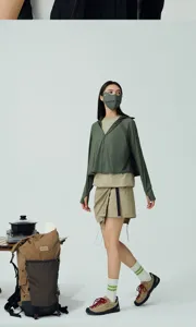 Lifestyle shot of a model wearing an olive green 3D ice silk sun protection mask outdoors