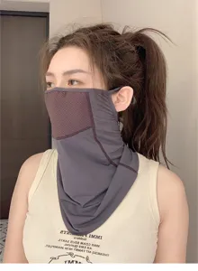 Close-up detail of breathable purple mesh sun protection face mask worn by model