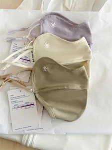 Close-up of three 3D ice silk sun protection masks with snowflake logo and UV tags