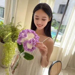Asian model holding a handmade purple and white crochet carnation flower bouquet.