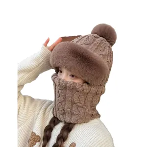 Women's brown winter knit hat with pom-pom and integrated face mask scarf combo
