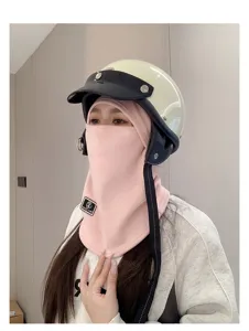 Close-up of pink winter windproof balaclava face mask with cycling helmet on a model.