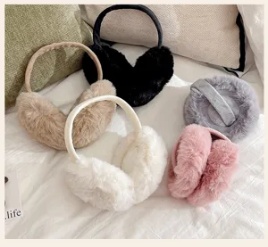 High-quality soft plush winter earmuffs in five colors displayed on cozy white bedding