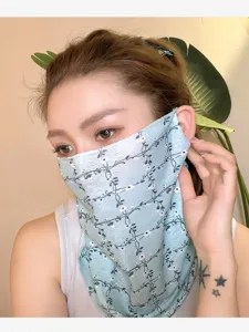 Close-up detail of light blue floral print sun protection half face neck mask for outdoor riding