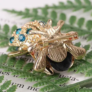 Detailed macro view showing the secure gold-plated pin clasp of the cute beetle brooch