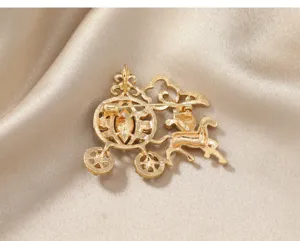 Detailed back view of golden hollow pumpkin carriage brooch with secure safety pin clasp