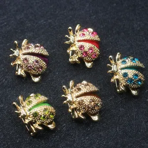 Detailed macro view of five colorful ladybug brooches with sparkling rhinestones