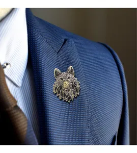 Detailed close-up of a vintage wolf head brooch with rhinestones on a blue suit lapel