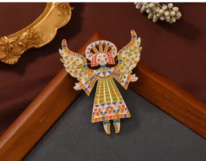Close-up of a colorful vintage mosaic style angel girl brooch with painted enamel details