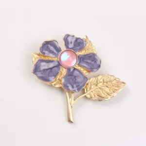 Detailed view of elegant purple cherry blossom brooch with pink cat eye stone