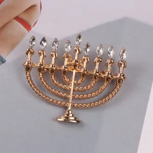 Detailed view of golden Hanukkah Menorah brooch with clear marquise rhinestones