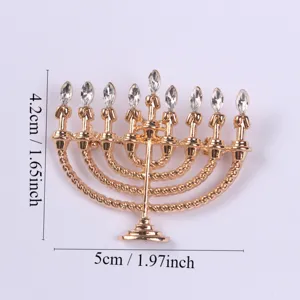 Detailed view of gold Hanukkah menorah brooch with sparkling clear rhinestone flame accents