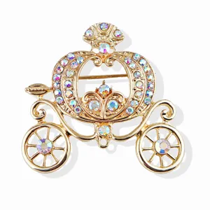 Macro view of a gold Cinderella pumpkin carriage brooch with iridescent rhinestones