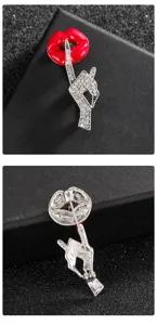 Macro detail showing the front and back of a creative red enamel lip brooch with crystals