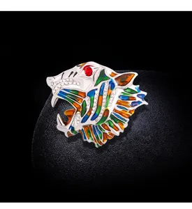 Detailed view of a colorful vintage tiger head brooch with rhinestones and enamel