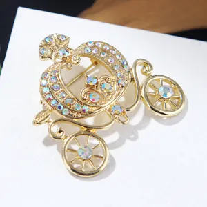 Close-up of a vintage Cinderella pumpkin carriage brooch with sparkling rhinestones