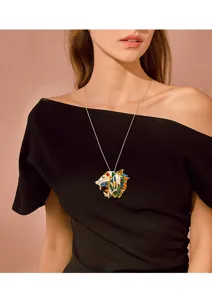 Detail of a Caucasian model wearing a vintage enamel tiger head pendant necklace
