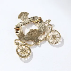 Detailed back view of vintage gold pumpkin carriage brooch showing the secure pin fastener